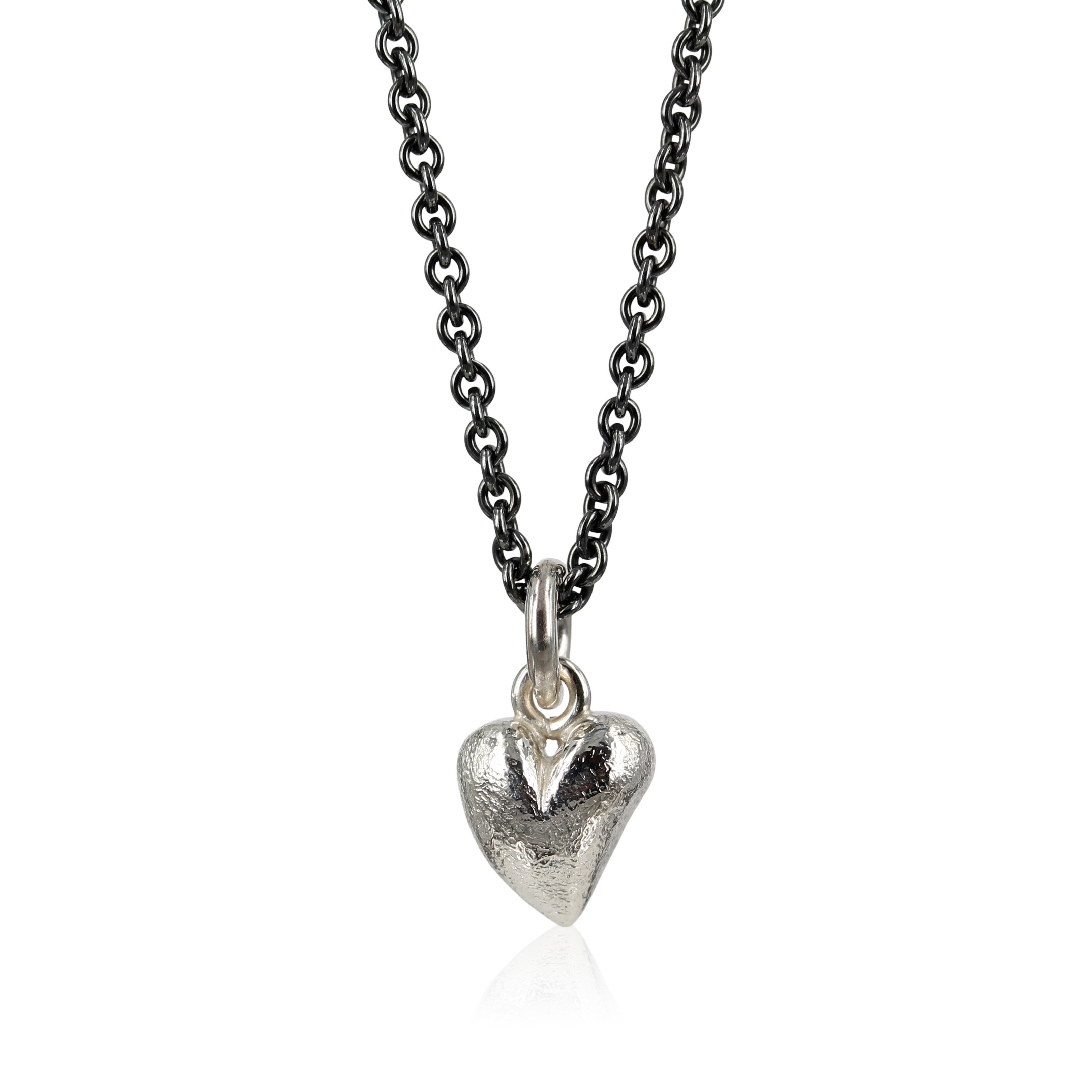 mat sølv - Love - Sølv hjerte vedhæng -  Lille fint sølv hjerte, designet med skæve buer i massiv sølv. Vedhænget er fint i en enkel kæde om halsen, eller som charm i et armbånd.
